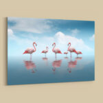 Flamingos im Wasser unter blauem Himmel Leinwandbild, Bild mit Rahmen oder Fotoposter
